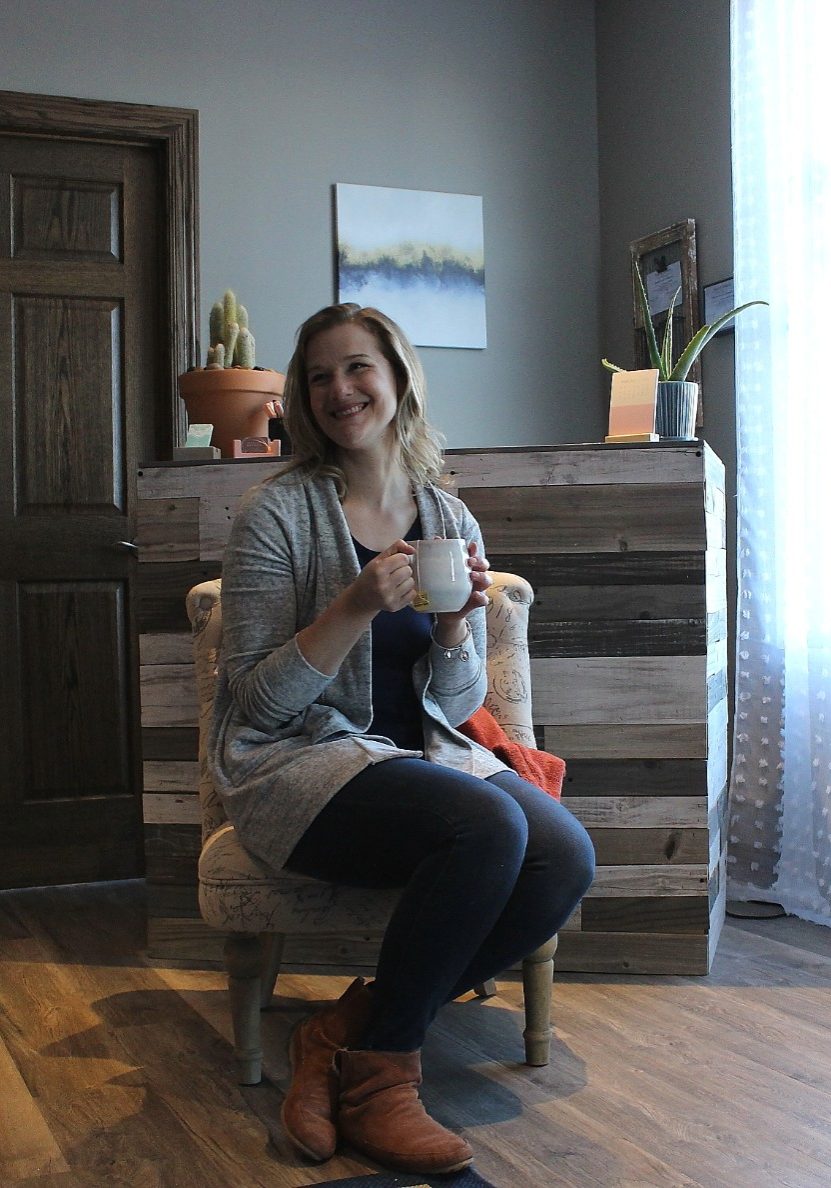 Eva enjoys a cup of coffee in a chair